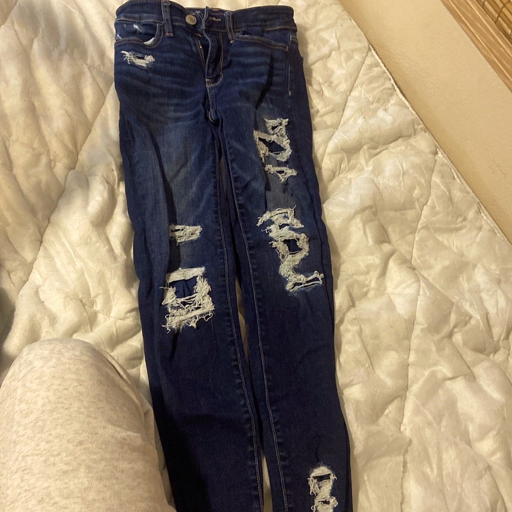 Navy blue patched ripped jeans from American eagle.